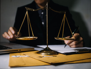 Business and lawyers discussing contract papers with brass scale on desk in office. Law, legal...
