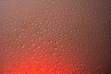 The effect of rain on a colored background.