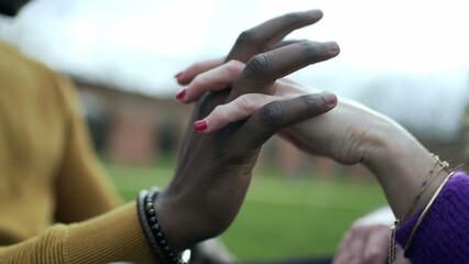 Black man joining hands with white girlfriend, interracial dating in union