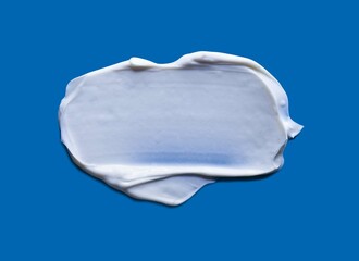 Cosmetic balm cream texture isolated on blue