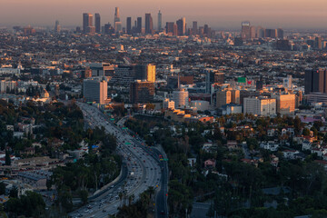 Naklejka na ściany i meble The 101 freeway leading into the downtown Los Angeles skyline at dusk