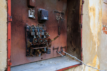 Old metal rusty electrical panel. Background with selective focus