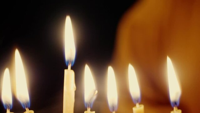 Burning candles in the Hanukkah menorah on the last day of Hanukkah. Medium plan