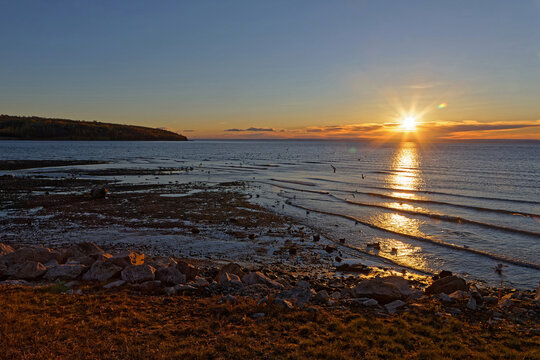 Sunrise over tje St-Lawrence river waters in La Malbaie, Quebec