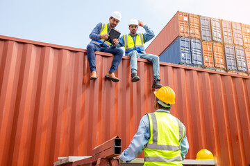 The professional engineer team is discussing the employee at container shipping company. Caucasian workers are planning transportation of goods to distributors through the ship.