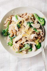 Whole grain penne pasta with chicken and green vegetables.