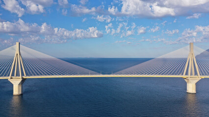 Fototapeta premium Aerial drone photo of famous state of the art modern cable strait bridge of Rio Antirio crossing corinthian gulf from Peloponnese seaside city of Rio to Antirio - mainland Greece