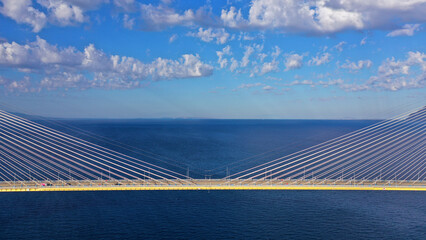 Aerial drone photo of famous state of the art modern cable strait bridge of Rio Antirio crossing corinthian gulf from Peloponnese seaside city of Rio to Antirio - mainland Greece