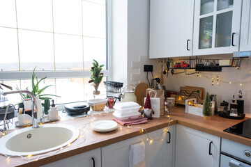 Food delivery service containers on table white scandi festive kitchen in christmas decor. Eve New year, saving time, too lazy to cook, hot order, disposable plastic box in fairy light. mock up