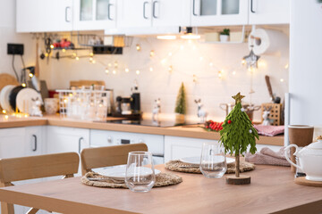 Festive Christmas decor and mess in the light kitchen, festive breakfast, white scandi interior. New Year, mood, cozy home 