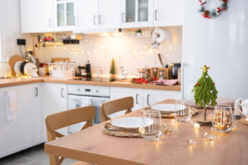 Festive Christmas decor and mess in the light kitchen, festive breakfast, white scandi interior. New Year, mood, cozy home 