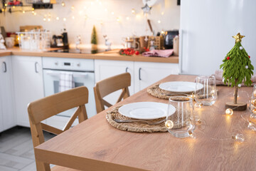 Festive Christmas decor and mess in the light kitchen, festive breakfast, white scandi interior. New Year, mood, cozy home 