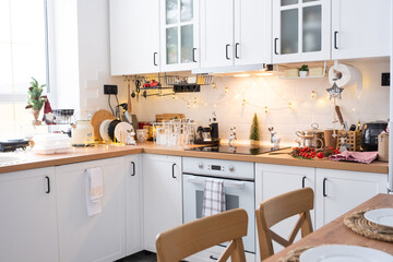 Festive Christmas decor and mess in the light kitchen, festive breakfast, white scandi interior. New Year, mood, cozy home 