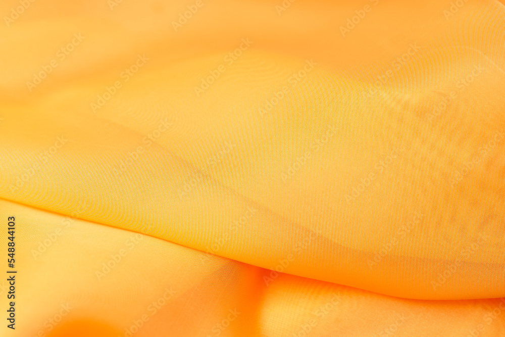 Sticker beautiful orange silk. wavy background fabric