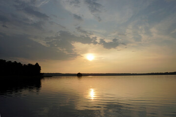 Quiet evening over the lake. The magic of the sunset and the charm of nature. Beautiful view.	