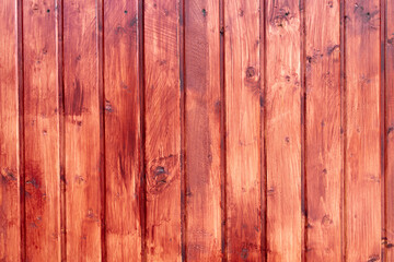 Fence made of wood colored with red paint. Carpentry backdrop with copy space