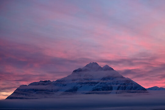 Cotton candy pastel winter sunrise over Alaska's Pioneer Peak.