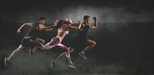 Sporty young man and woman running on dark background