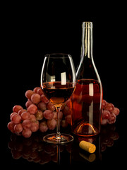 Uncorked bottle of wine, wine glass and bunch of grapes