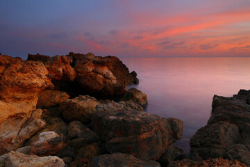Fototapeta na wymiar Sunset at Talamanca Beach with limestone rock formations. Santa Eulalia, Ibiza, Spain.