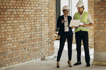 Business woman talking with architect at the construction