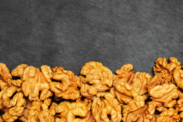 Walnuts. Walnut kernels on dark stone table. Top view