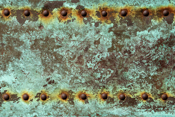 green verdegris background with rusted rivets