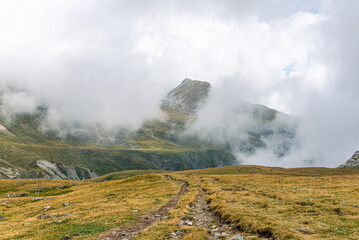 Mountain peak with misty clouds.