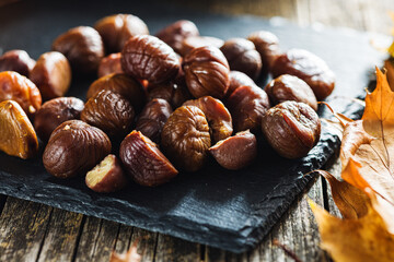 Peeled chestnuts. Sweet roasted chestnuts on cutting board.