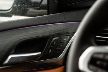 Fototapeta na wymiar Car door lock unlock button close up. Modern car door lock. Door control panel in a new car.