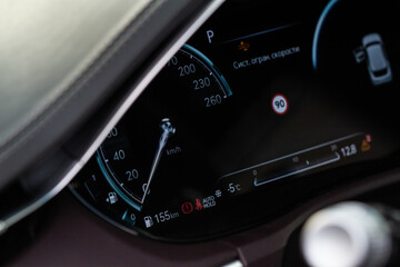 Modern car dashboard with speedometer, tachometer. Car dashboard. Car dashboard details. Modern car interior. The speedometer of a modern