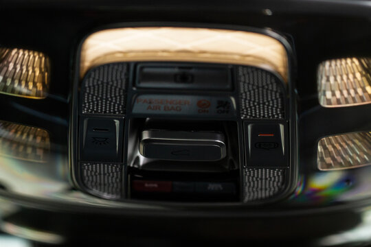 Close up image of the SOS button and car ceiling lamp in a car.