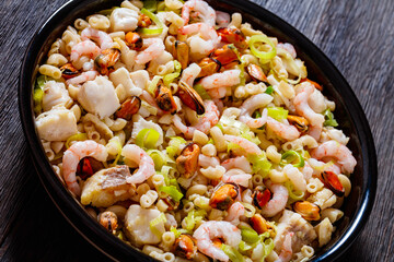macaroni salad with shrimps, mussels, fish, leek