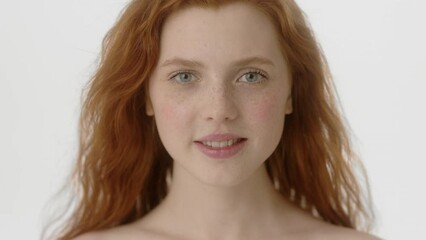 Beauty Woman face Portrait. Beautiful Spa model Girl with Perfect Fresh Clean Skin. Caucasian Female with Ginger haircut looking at camera and smiling. Youth and Skin Care Concept. Isolated on a white
