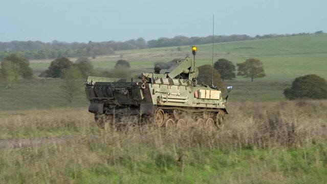 British army FV434 Bulldog REME recovery vehicle in action on a military battle exercise, Wiltshire UK