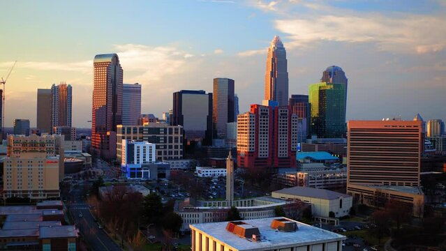 Aerial Forward Shot Of Tall Office Towers In Residential City During Sunset - Charlotte, North Carolina