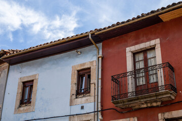 Colored houses and a blue sky behind them