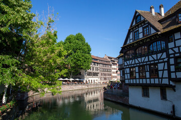 Fototapeta na wymiar Colored houses in a French village along a canal in the Alsace area