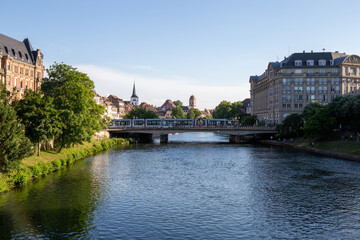 Fototapeta na wymiar River in a French city over which a bridge with a tram passes