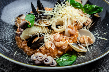 Risotto with seafood shrimp and mussels in shells, Food recipe background. Close up