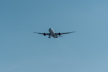 Fototapeta na wymiar Horizontal view of a commercial airliner full of passengers descending toward the runway