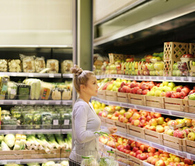 Woman buying fruits and vegetables at the market