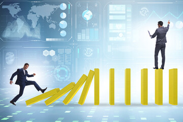 Businessman in domino effect concept
