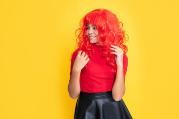 smiling teen child with red long hair on yellow background