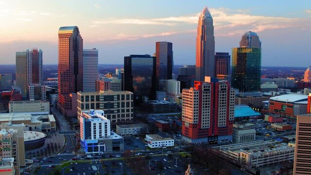 Aerial Shot Of Tall Skyscrapers In Residential City, Drone Flying Backwards During Sunset - Charlotte, North Carolina