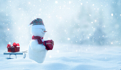 Two  cheerful snowman  standing in winter christmas landscape. Winter fairytale.Snowfall in the...