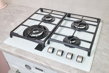 Modern hob gas stove made of tempered white glass using natural gas or propane for cooking products...