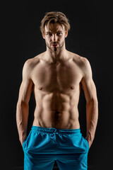 Fototapeta na wymiar photo of young man with muscular abs. muscular man with abs isolated on black background