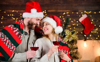 Romantic evening. Christmas ideas for couples. Romantic date with red wine. Man and woman in love cuddling enjoy intimacy festive atmosphere. Romantic couple. Family celebrate winter holiday at home