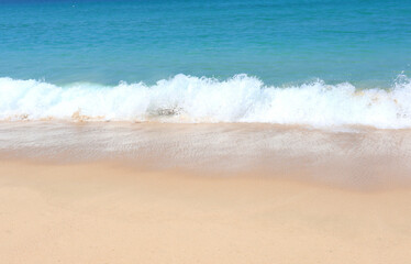 Warm waves of a tropical beach wash the sand